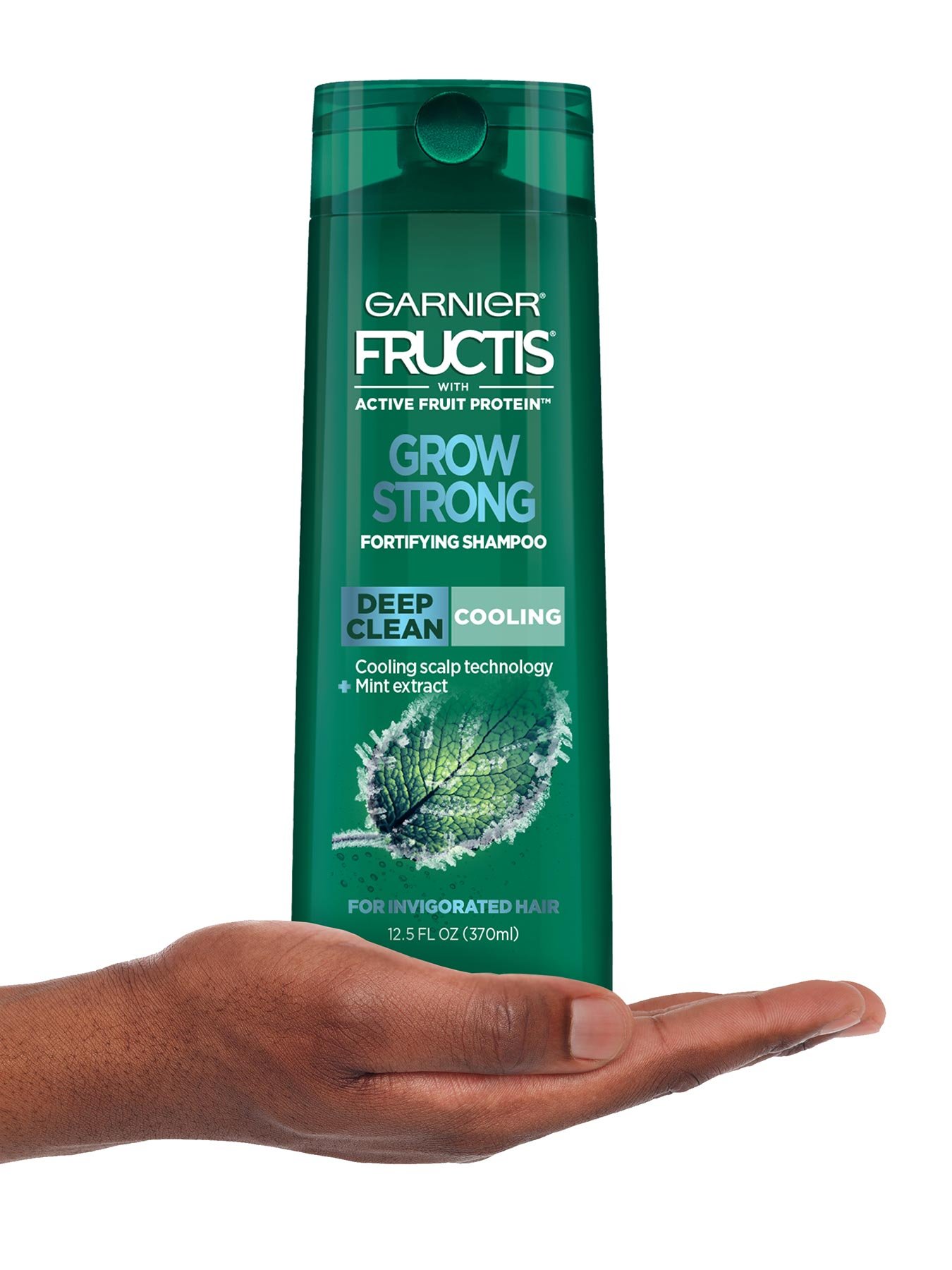 Hand holding Cooling Deep Clean Shampoo for Men for Invigorated Hair.
